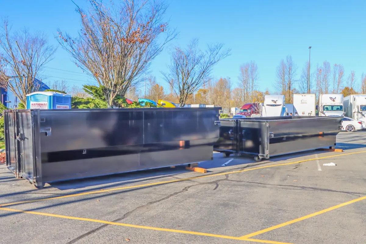 Professional dumpster rental service with roll-off container on residential driveway in Anderson Creek